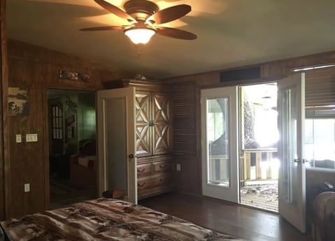 master bedroom- private deck with 2 lounge chairs & fan