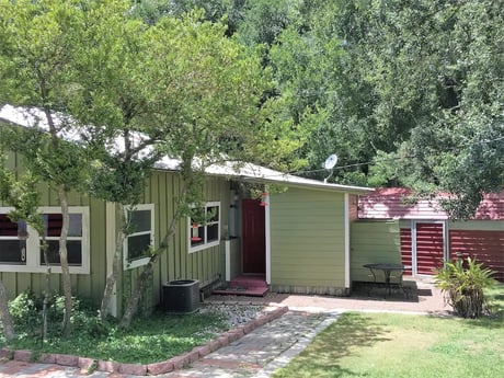 outdoor shower to right going to red shed
Full size washer and dryer in shed
fishing eqpt. and water toys and life vests storage